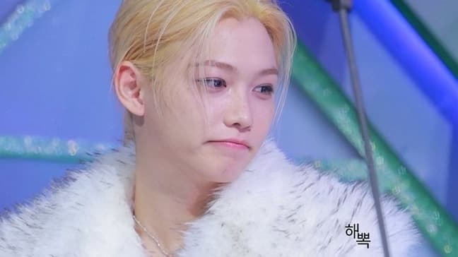 A Stray Kids member holds an award — KARMA would go on to win Album of the Year at the 2025 MAMA Awards