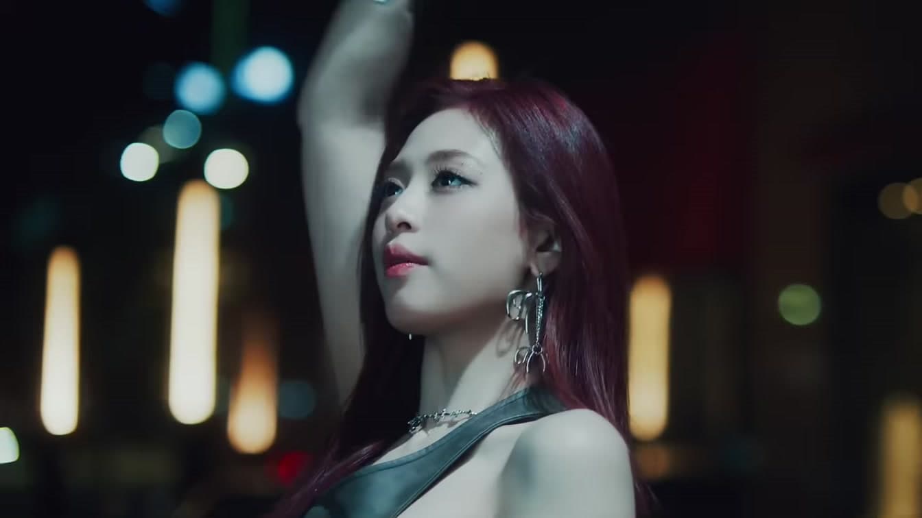 A BABYMONSTER member performs in a music video, capturing the powerful visual identity of YG's girl group ahead of their 'CHOOM' comeback on May 4