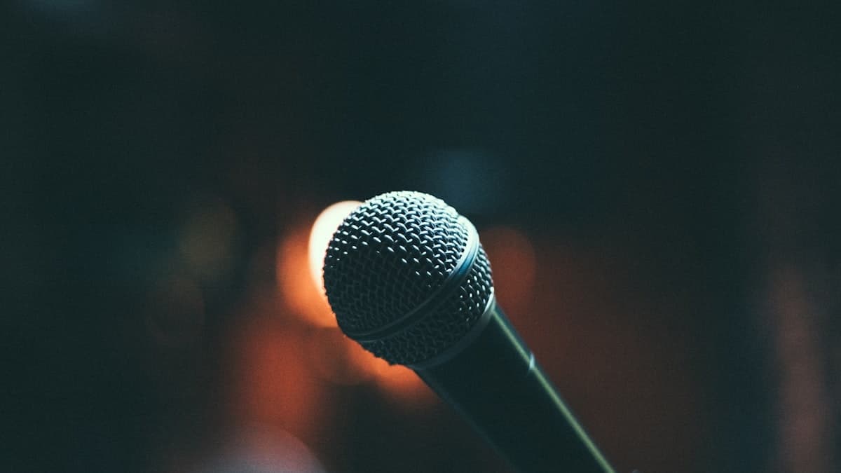 A microphone on a concert stage, representing Kim Sung Su's enduring career as a singer