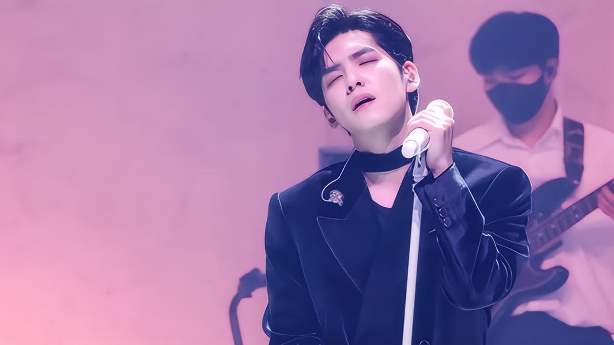 Wonpil performing with visible emotion at his first solo concert, a defining moment in his growing solo career
