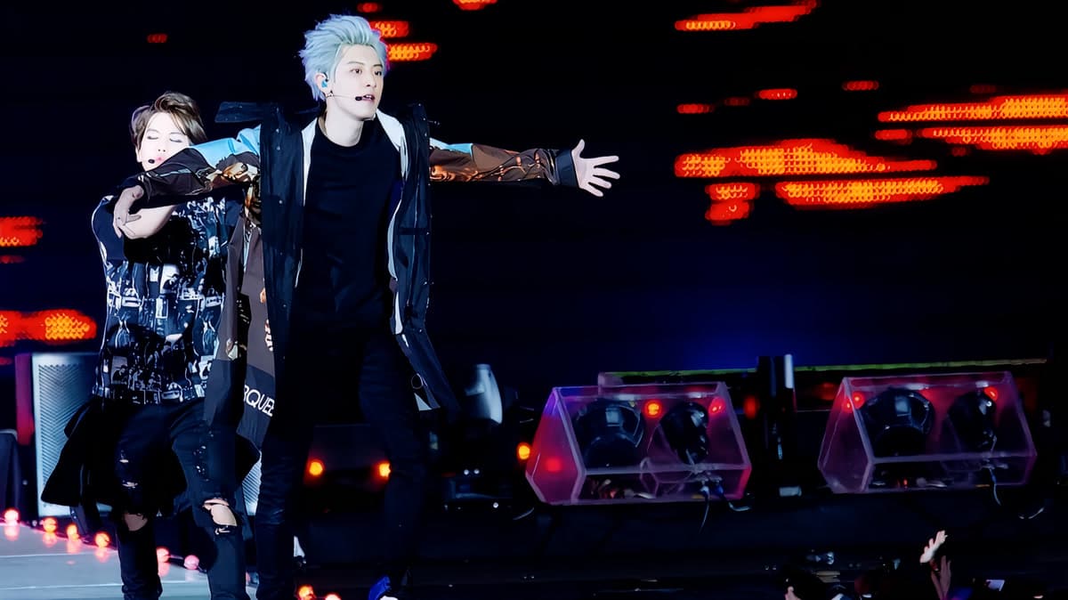 EXO members performing on stage during a spectacular live concert