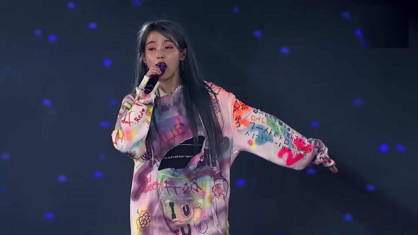 IU performing during her Love, Poem concert tour — she shared an unscripted emotional moment on 'I Live Alone'