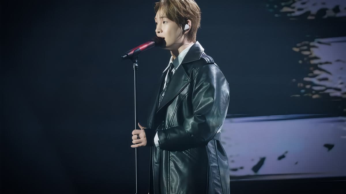 SHINee's Onew performing at his TOUGH LOVE fan meeting in April 2026